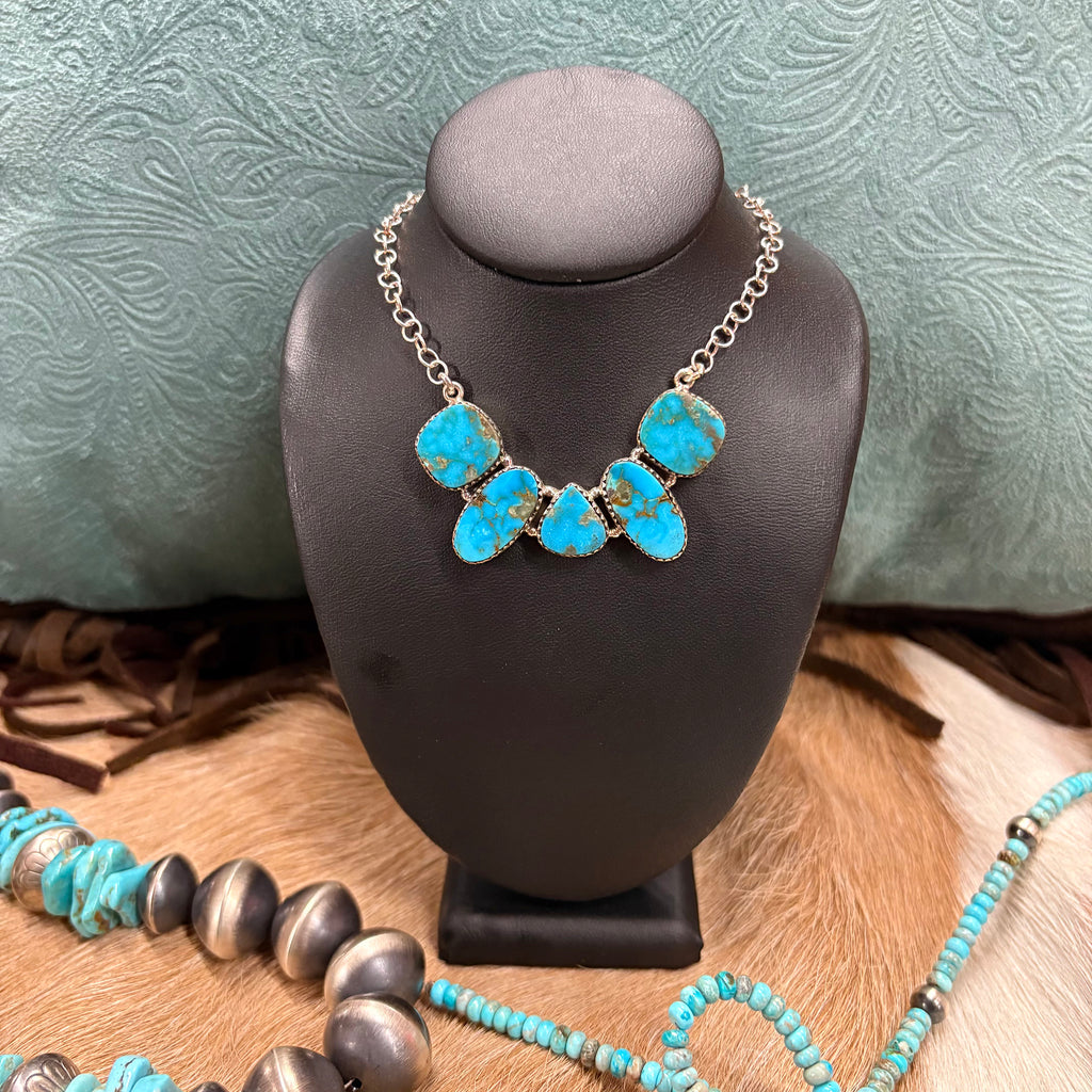 Sterling Silver necklace with 5 Kingman turquoise stones in a curved shape 