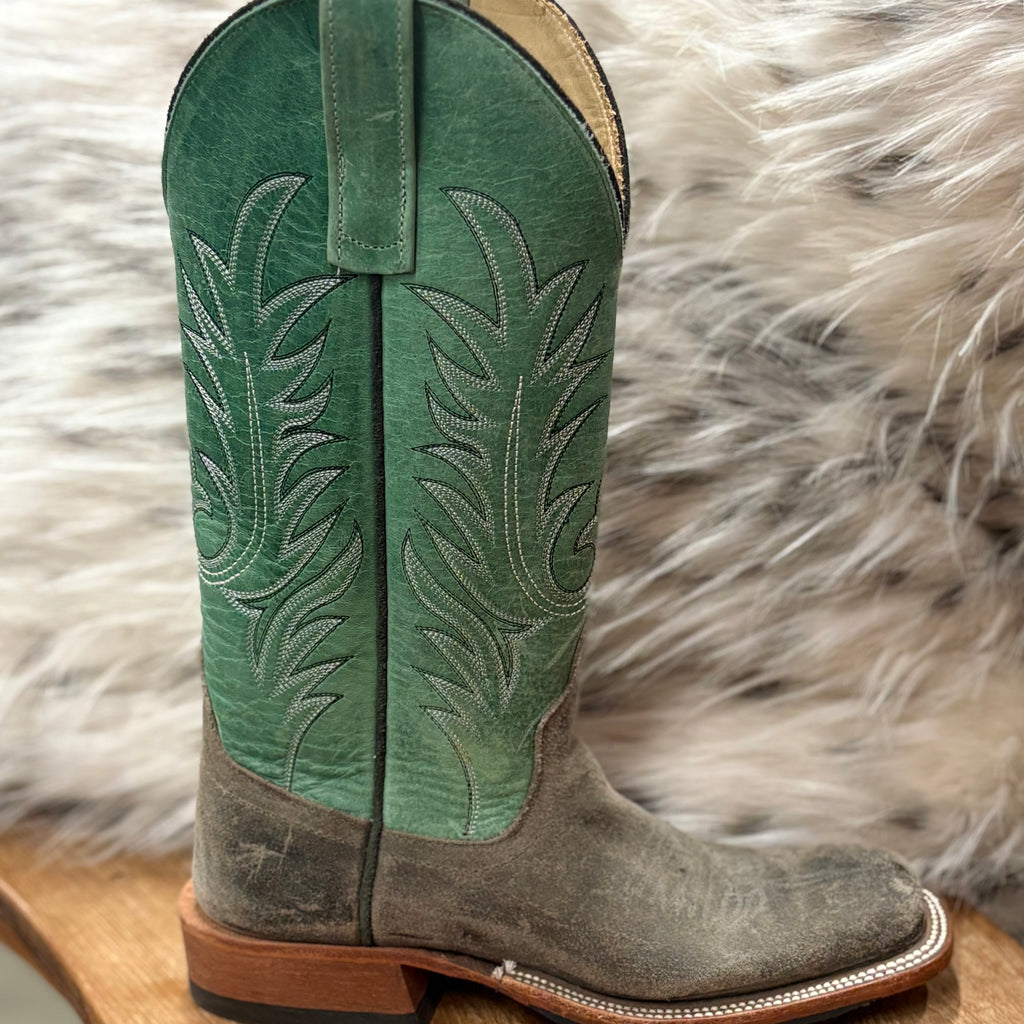 SIngle boot angled right showing green shaft with silver boot stitching 