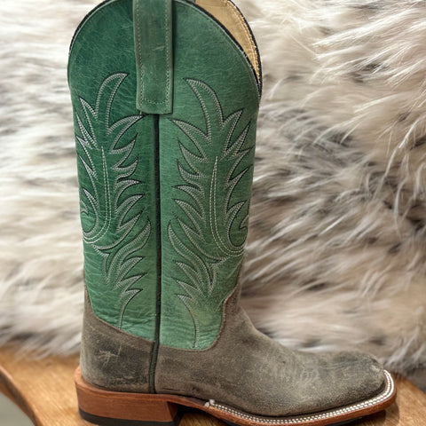 SIngle boot angled right showing green shaft with silver boot stitching 