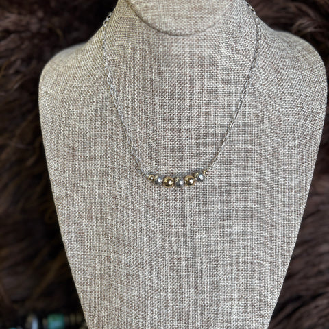 Chain necklace with alternating gold and stamped Navajo pearl necklace 