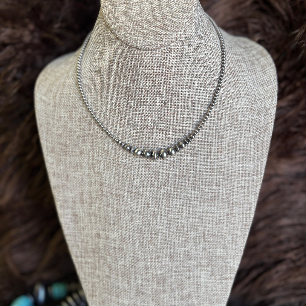 14 in necklace with graduated Navajo pearls that range from 3-9mm with the biggest pearl in the middle.