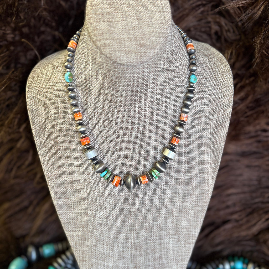 18 in Navajo pearl necklace with mixed in spiny oyster stones and turquoise stones. Navajo pearls varied in size and shape.