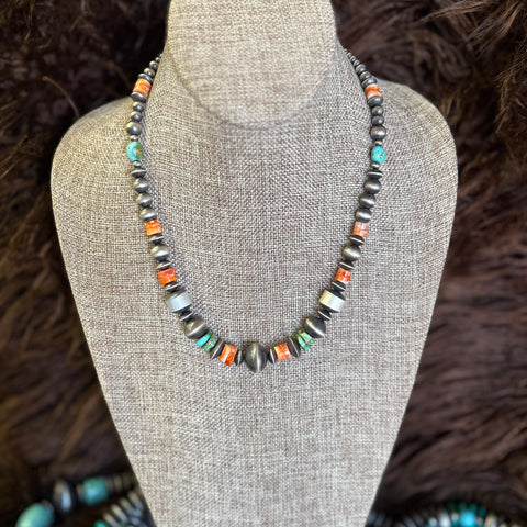 18 in Navajo pearl necklace with mixed in spiny oyster stones and turquoise stones. Navajo pearls varied in size and shape.