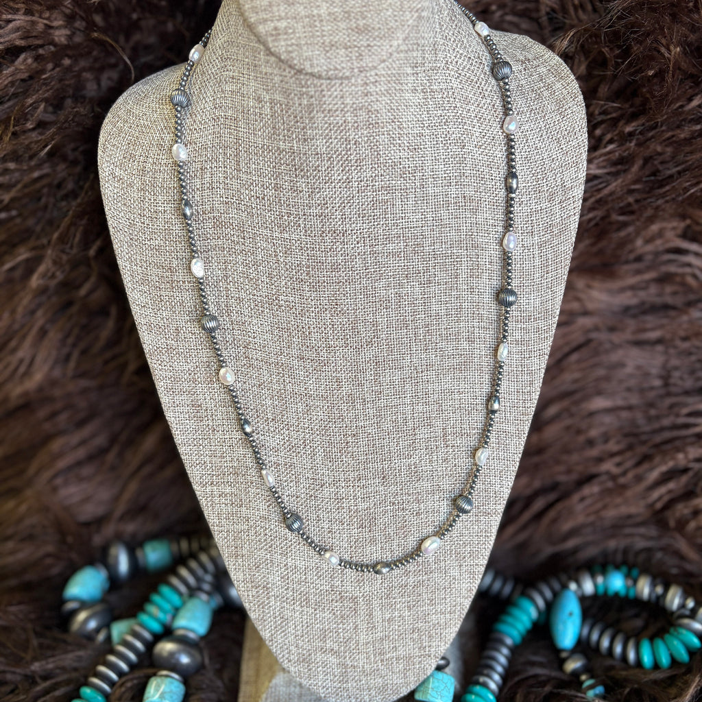 28 Inch length necklace with small Navajo pearls mixed with large striped pearls, oval Navajo pearls, and regular pearls.