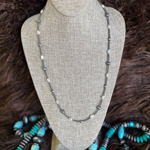 28 Inch length necklace with small Navajo pearls mixed with large striped pearls, oval Navajo pearls, and regular pearls.