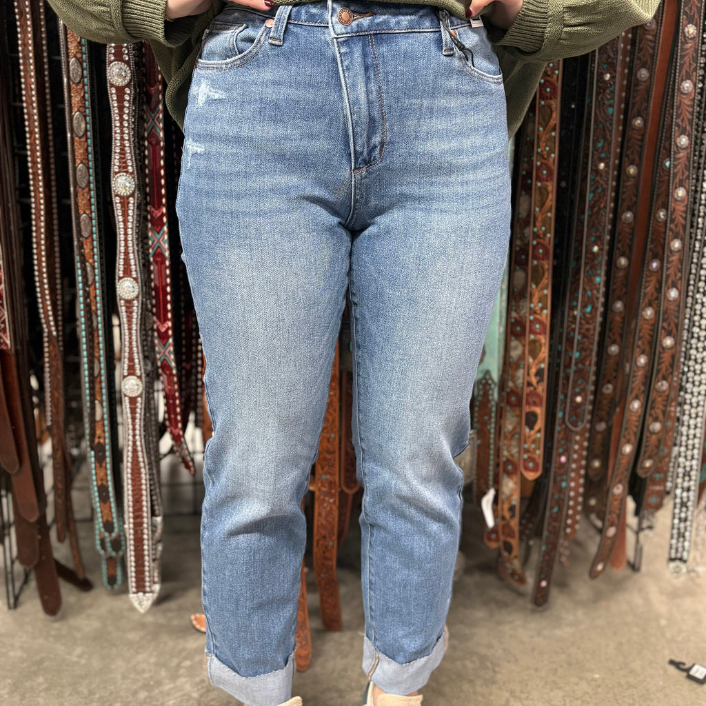 Front view of jeans, light blue with rolled cuff. Small distressed details under left pocket.