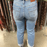 View of the back of the jeans, simple brown stitched design on pockets.