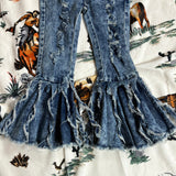 Close up view of the bell bottoms, wide flare and distressed/torn detailing.