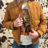 Font view of model wearing jacket unzipped, small turquoise steer head on left shoulder.