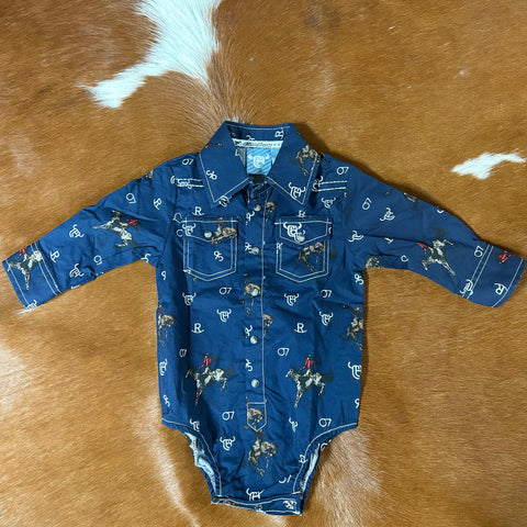Flat lay view of a long sleeve navy onesie with retro bronc designs and white brand designs. Onesie has two front pockets and pearl snap closures. 