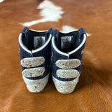 Back side of the boots, two Velcro straps for closure and are white glitter. 