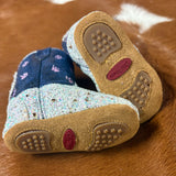 Bottom of the boots, they are brown with rubber pieces on the toes and heel. 