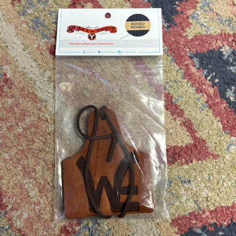 Brown leather air freshener in the shape of a cattle ear tag. it has a Large Dark Western Edge Logo on it and has a leather string.