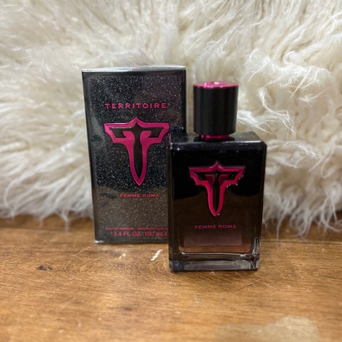 Bottle  and box of perfume, bottle is black with pink sparkles. Cap has a shiny pink top and bottle has a shiny pink and black "T" with "Femme Roma" under the logo.