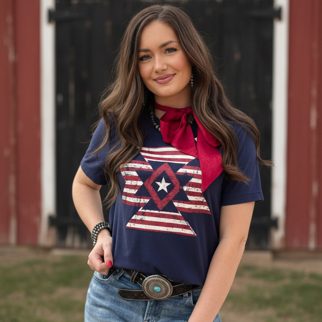 Model Wearing Navy Freedom Aztec Tee Standing in Front of a Barn