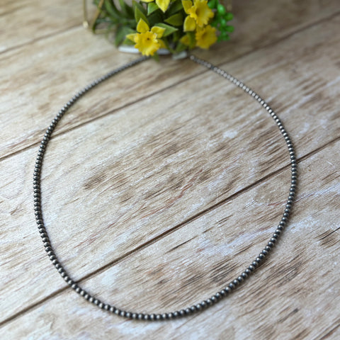 Flat lay of Navajo pearl string necklace with 4mm size pearls.