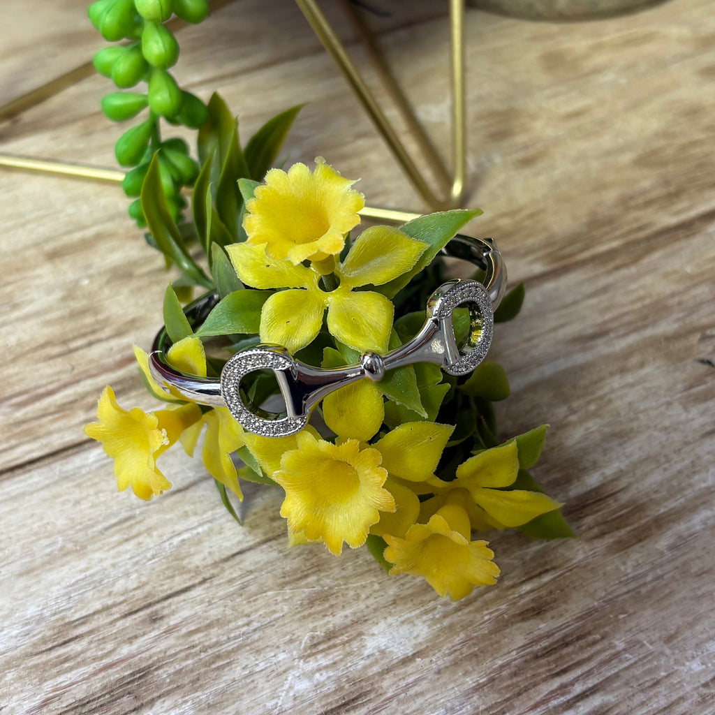 Silver bracelet with a horse bit on the front with rhinestone accents.