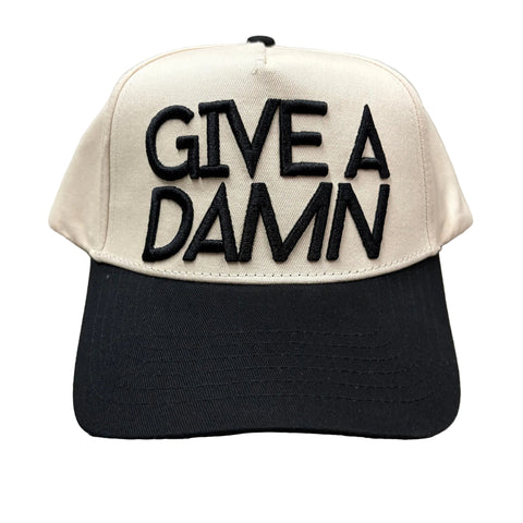Front side view of tan and black Give A Damn Cap. 
