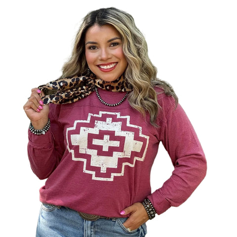 Model is wearing maroon long sleeve t-shirt with a distressed white Aztec Design in the middle. 