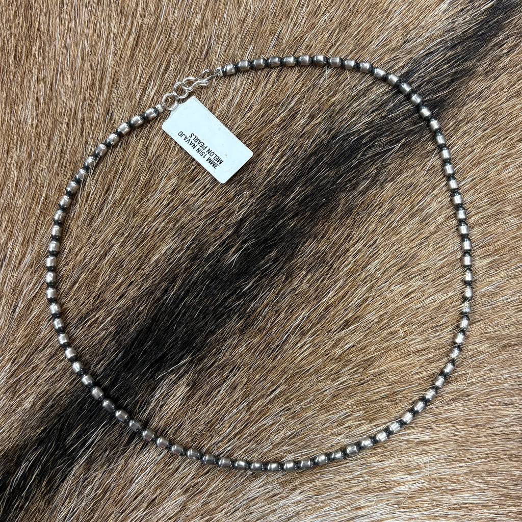 Full view of "June" necklace laying on cowhide