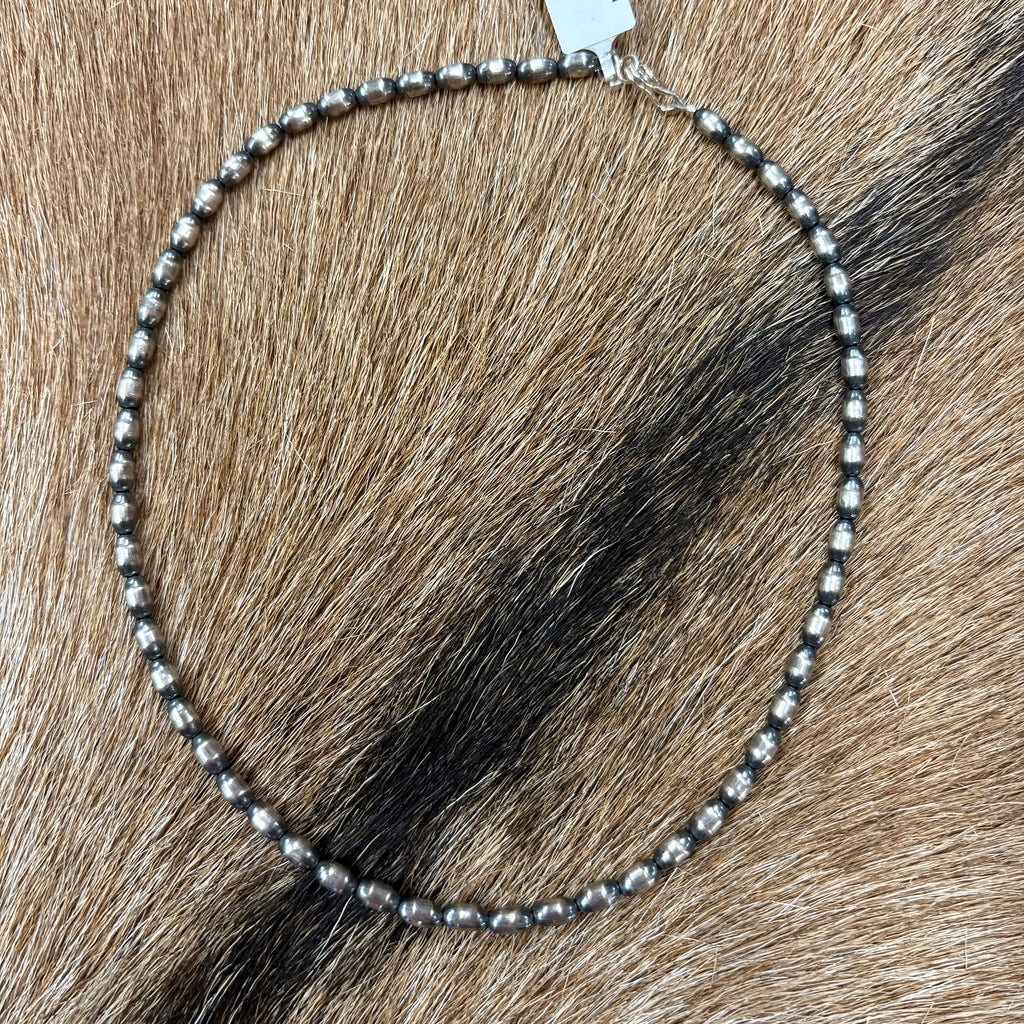 Full view of "Haven" Necklace laying on cowhide