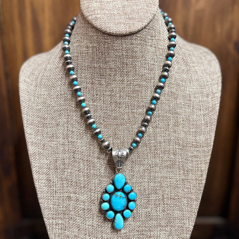 "Cecelia" Navajo Pearl & Turquoise Cluster Pendant Necklace sitting on mannequin.