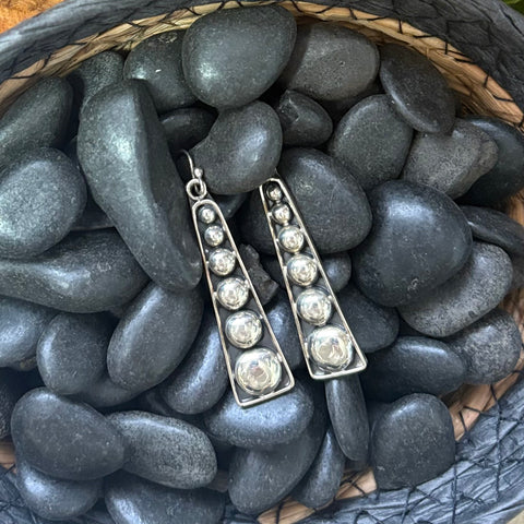Close up view of the "Dottie" Black & Silver Dot Long Bar Earrings 
