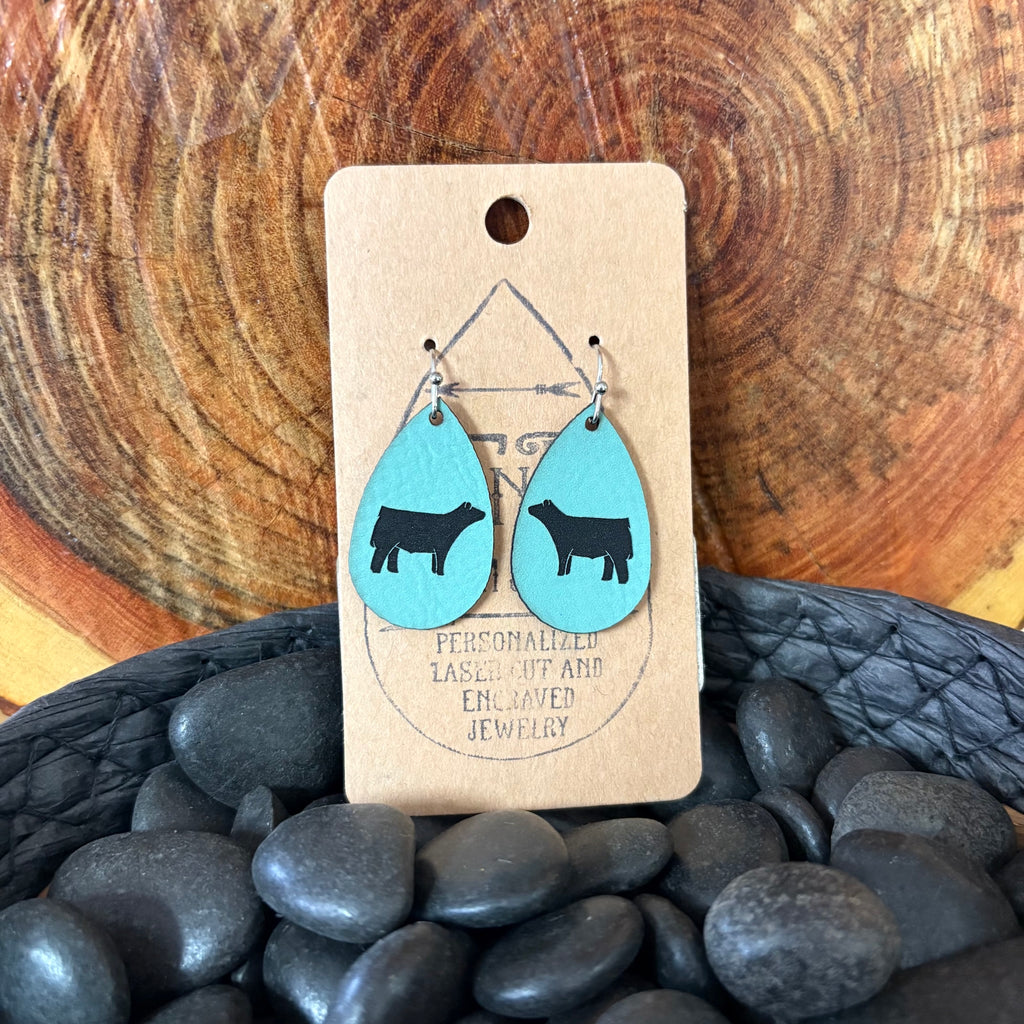 Close up view of Small Teal Show Steer Earrings 