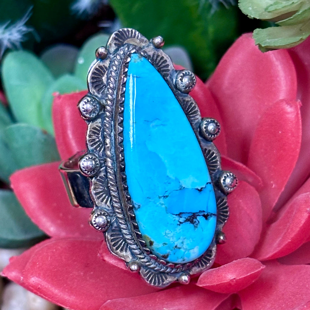 Close up view of a Kingman turquoise oblong teardrop adjustable ring