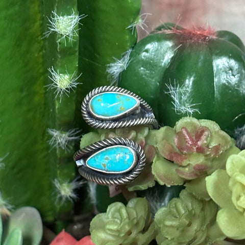 Close up view of a double turquoise teardrop adjustable ring