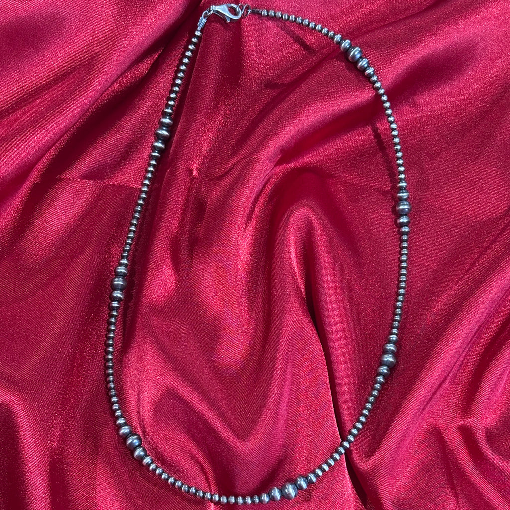 Close up view of a multi graduated Navajo pearl necklace.
