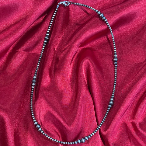 Close up view of a multi graduated Navajo pearl necklace.