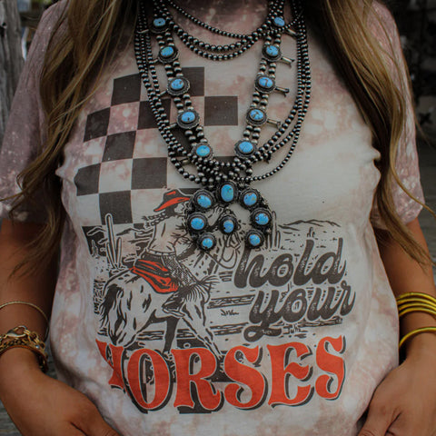 Front side view of model wearing the shirt, paired with western jewelry.