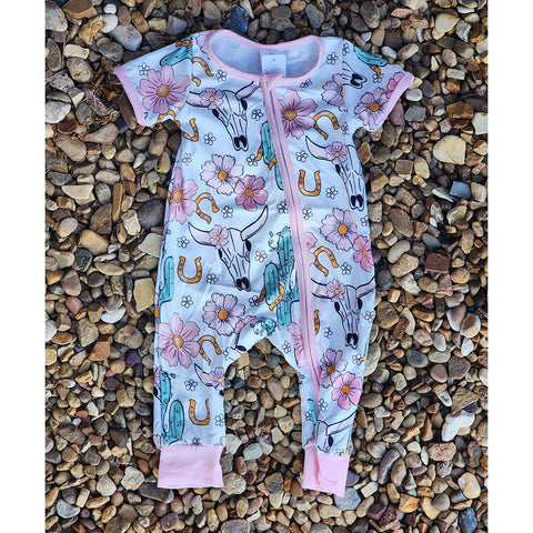 Infant girls pink romper with bull skull and cactus print, zipper closure, and Western boutique style