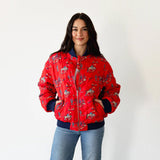 Model wearing the Red Quilted Cowboy Bomber Jacket, showing the bold red quilted design and cowboy graphics