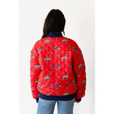 Back View of model wearing the Red Quilted Cowboy Bomber Jacket, showing the bold red quilted design and cowboy graphics