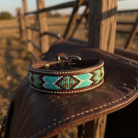 Leather dog collar with geometric turquoise, white, gold, and black beads. Middle of the design has a cross. 