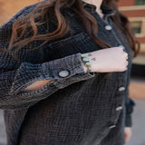 Close-up of the Midnight Acres Button Up showing the matching buttons and subtly textured fabric.