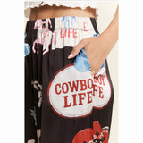 Black pants with 'Cowboy Life' text and western graphics