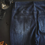 Close up pocket view of dark wash line drive jeans.