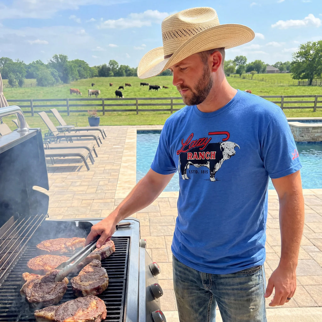 Model wearing the blue Lazy J Ranch Beefmaker T‑shirt in a casual outdoor setting, showing the soft fabric and easy Western everyday style.