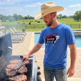 Model wearing the blue Lazy J Ranch Beefmaker T‑shirt in a casual outdoor setting, showing the soft fabric and easy Western everyday style.