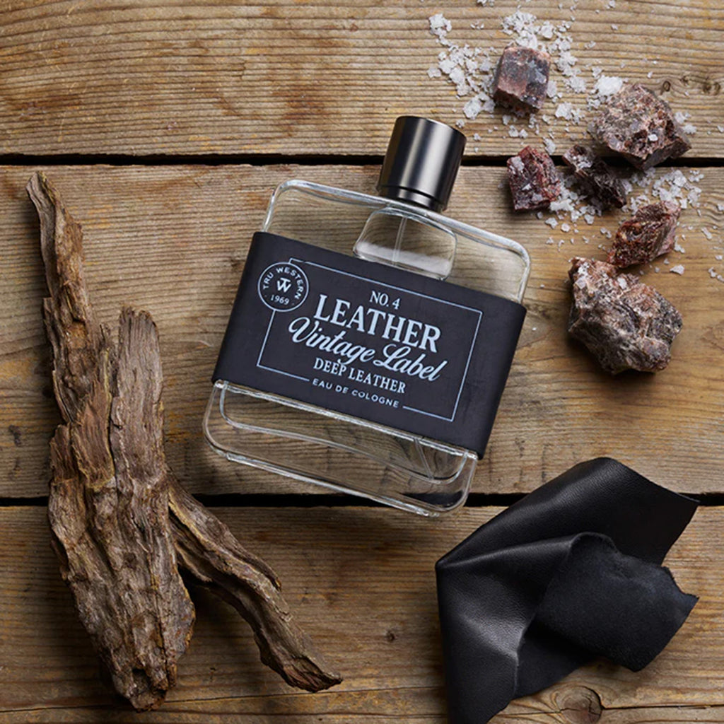 #4 Deep Leather Cologne on a wood background with leather, salt & black amber and driftwood 