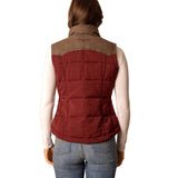 Back view of a  woman wearing a burnt red colored puffer vest with chocolate yoke.