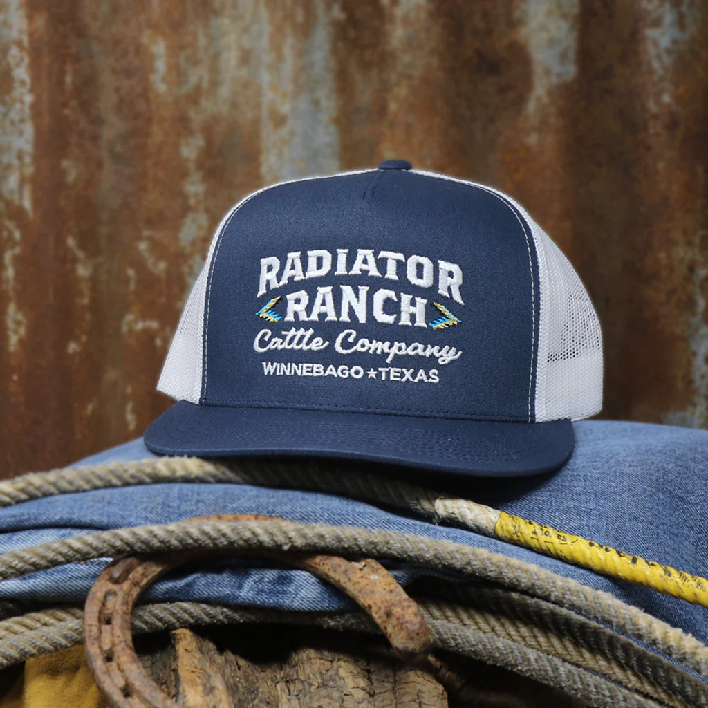 Navy blue ball cap with white mesh backing. Navy blue front has embroidered Radiator Ranch Cattle Company Winnebago Texas" written on it.