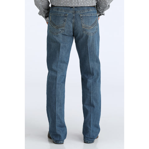 Man wearing the Cinch Men’s Grant Jean, back view showing the embroidered chevron‑patterned pockets and classic Cinch stitching.