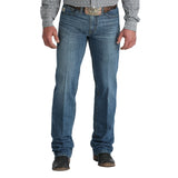 Man wearing the Cinch Men’s Grant Jean, front view showing the relaxed fit, medium‑wash denim, and subtle hand‑sanding details.