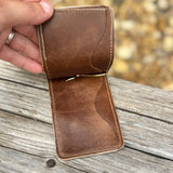 Inside of light brown card holder with money clip.