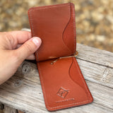 Inside of light brown card holder with money clip.