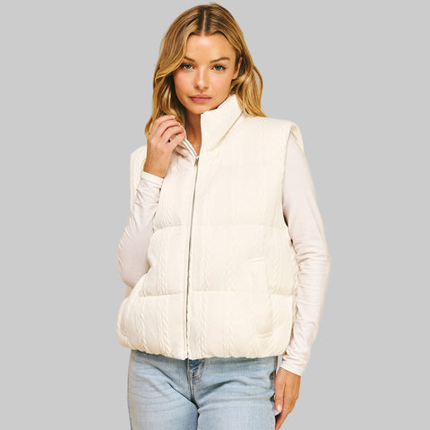 Front view of a woman wearing a textrured white puffer vest
